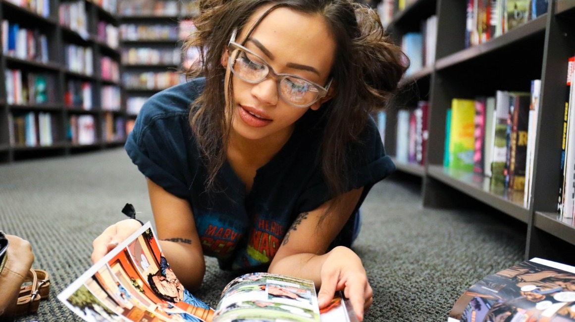 Woman reading a comic book in a comics store