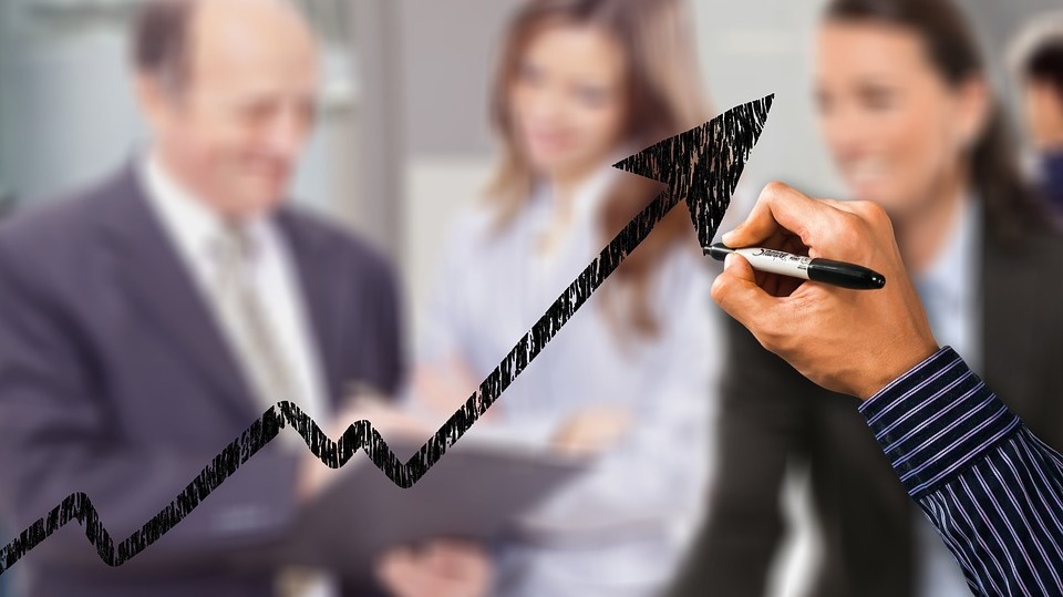 a hand drawing the arrow of growth on a chart