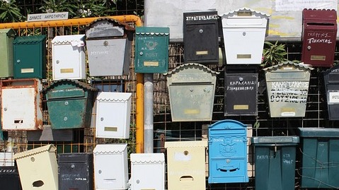 Mailboxes Lined Up On A fence