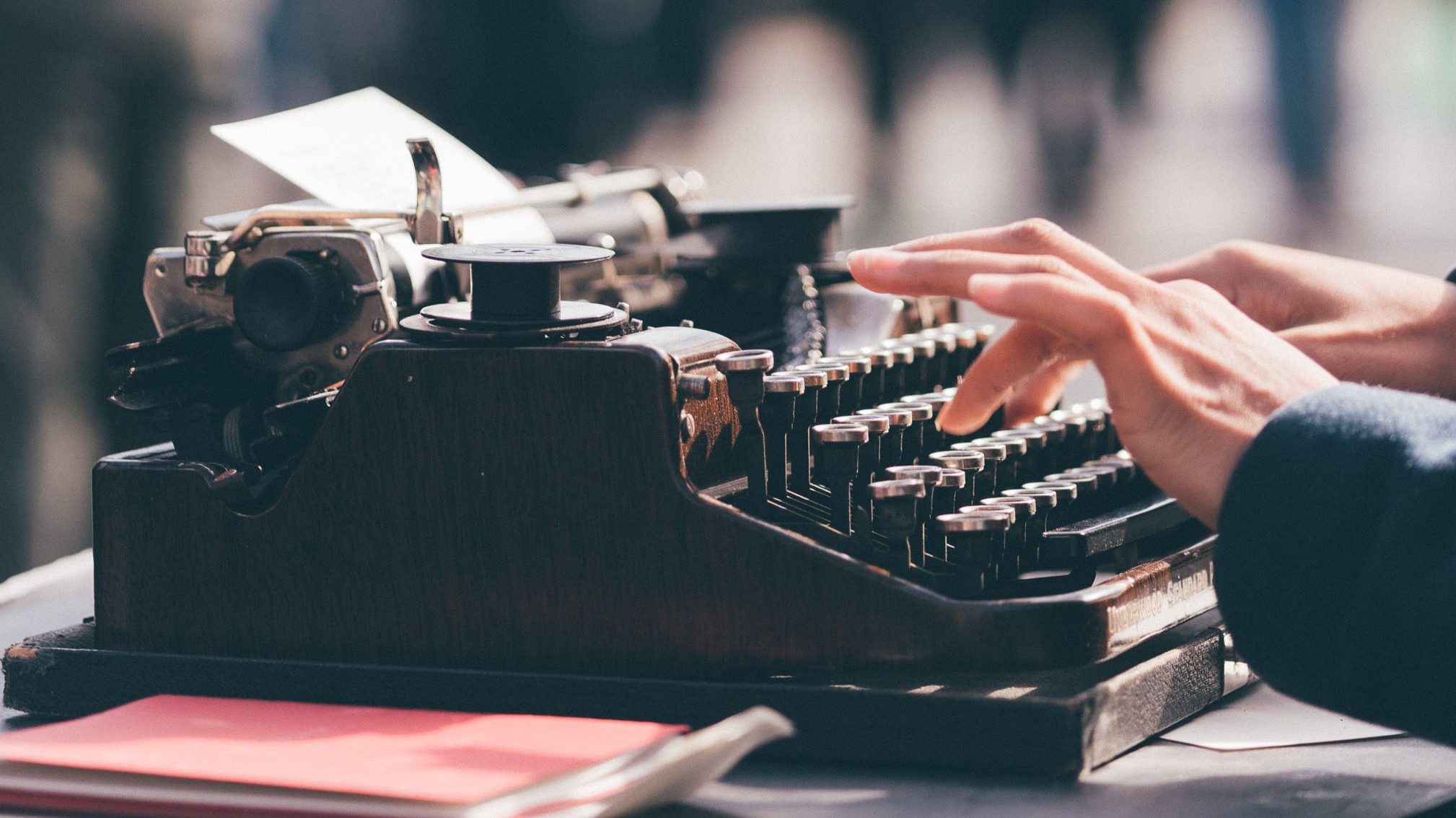 Person typing on a typewriter