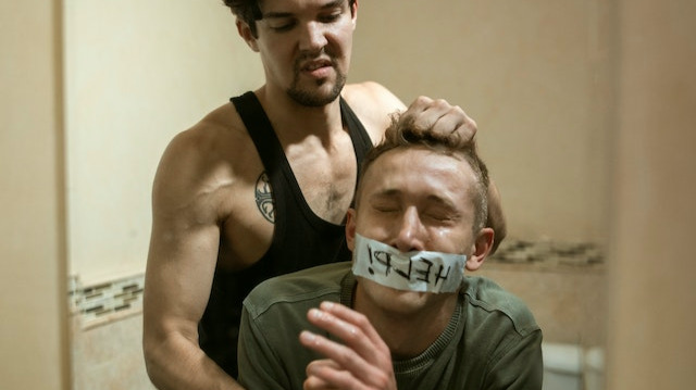 A Man pulling another's hair