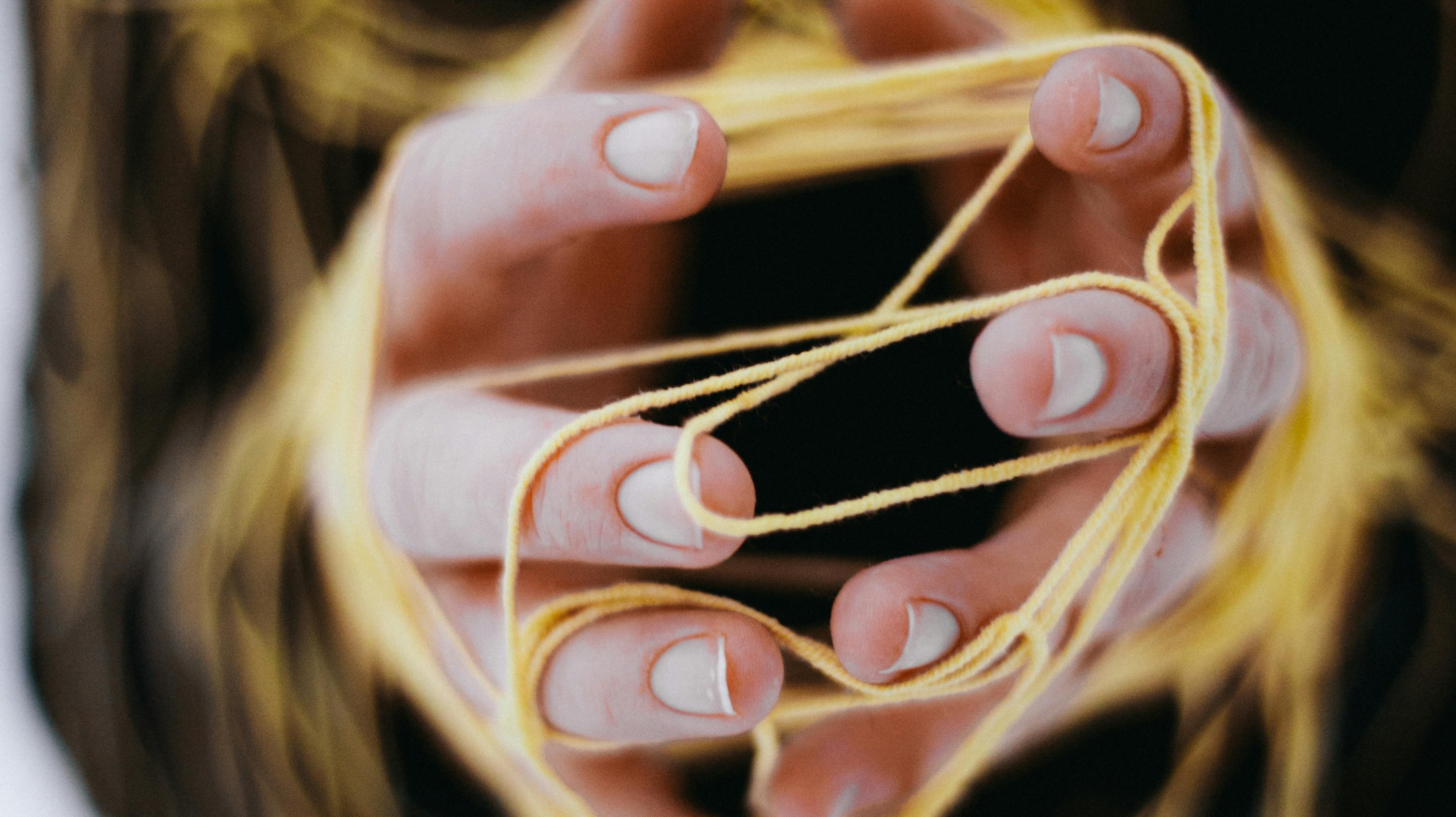 Photo by Анна Малышева (Заволока): https://www.pexels.com/photo/close-up-of-woman-hands-tangled-with-string-12298480/