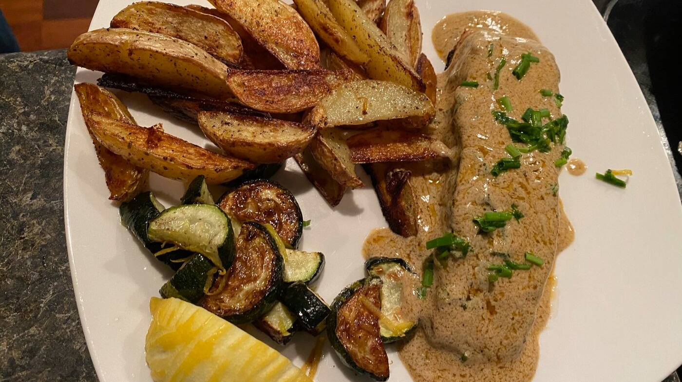 Salmon in a buttery sauce with zooks