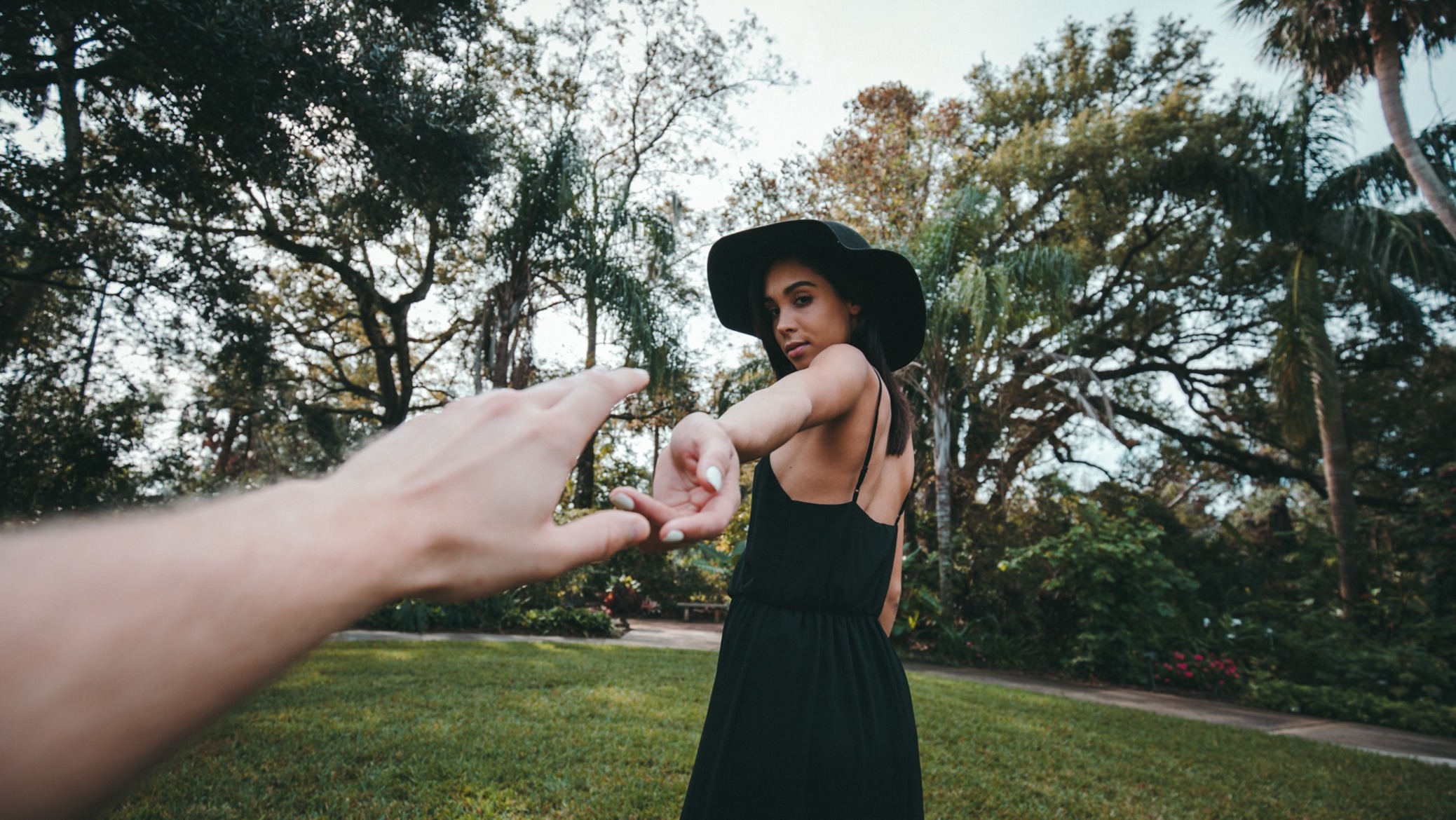 man's hand reaching for a woman walking away