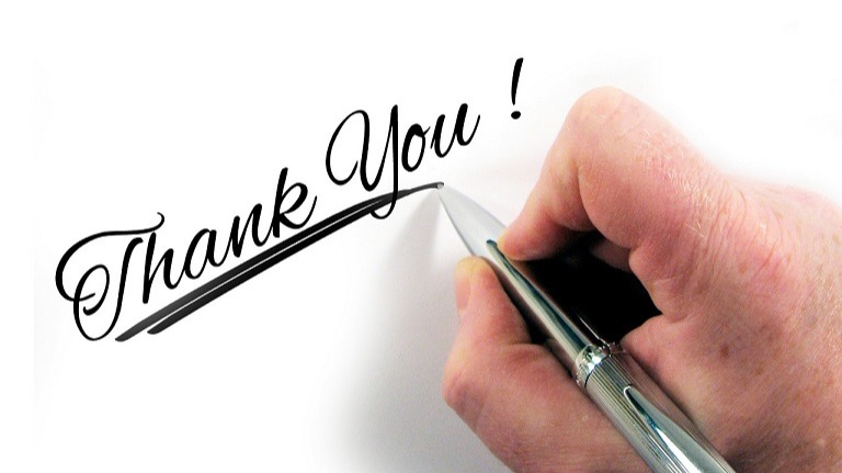 Hand with pen writing thank you!