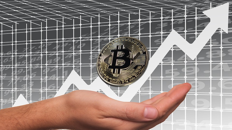 bitcoin on a hand in front of an ascending arrow
