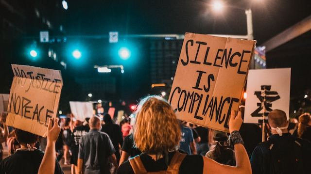 Protesters holding signs