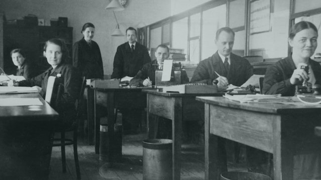 B&amp;W photograph of workers in a classic office