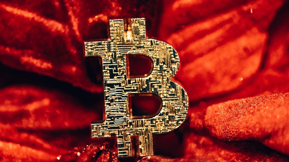 There is a sign of Bitcoin on the red fabric in the picture