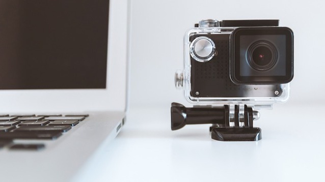 A Video Camera Sitting Next to a Laptop