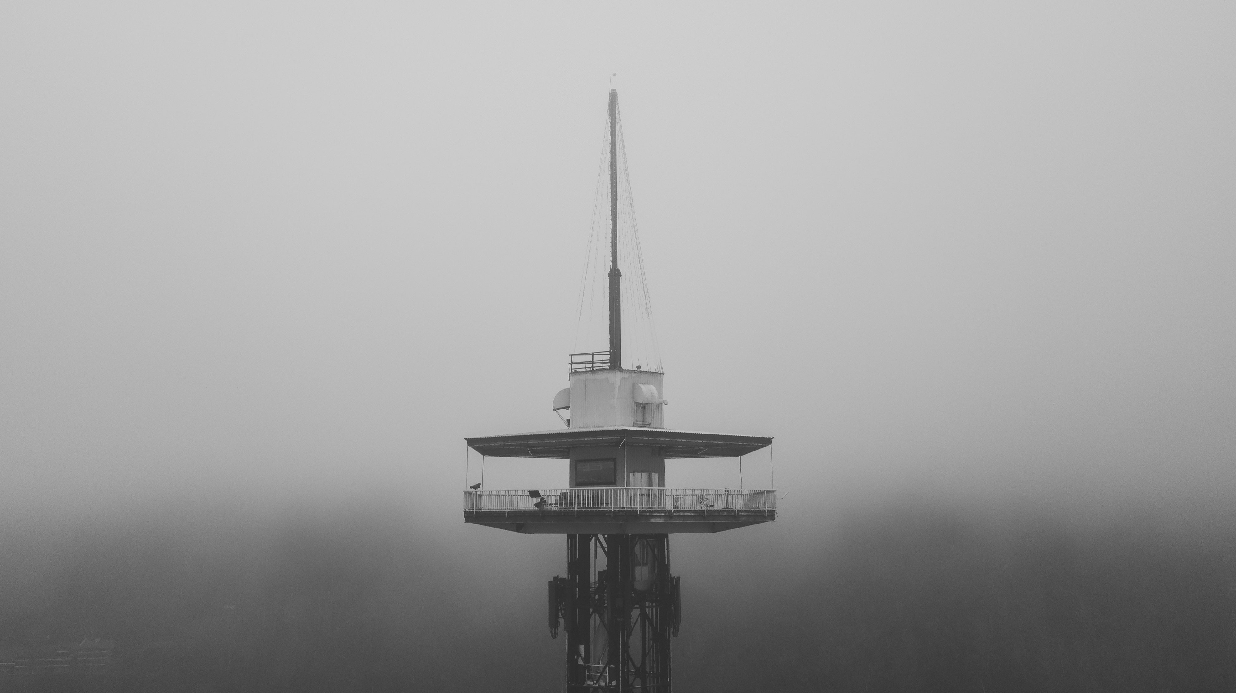 Space Needle in Gatlinburg, Tennessee in the clouds and in black and white.