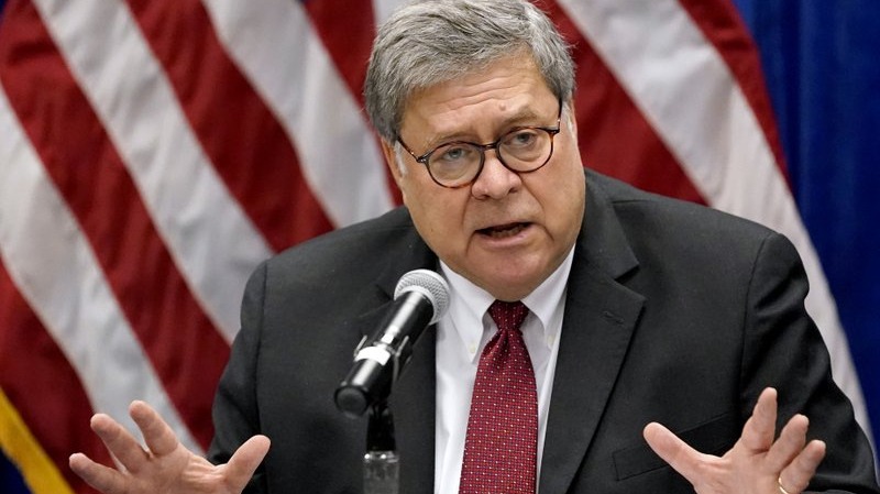 William Barr standing at a podium